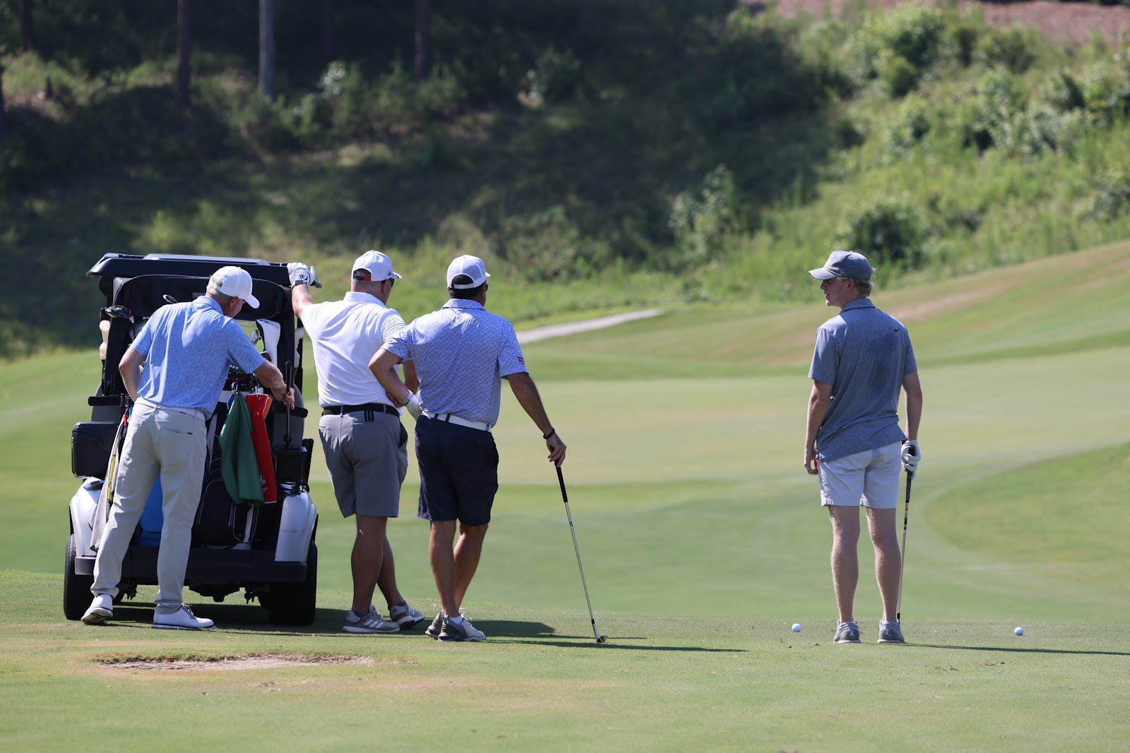 A foursome talking together between shots